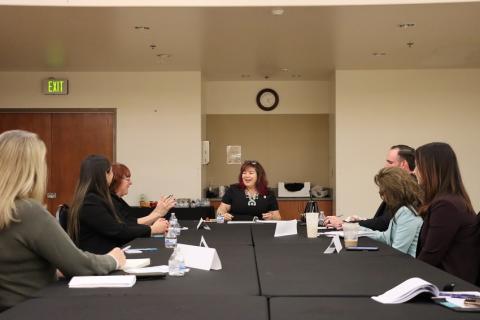 people sitting at a desk having conversation