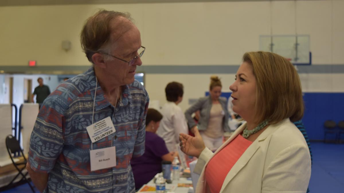 Congresswoman Sanchez speaks with a constituent at her Senior Fair.